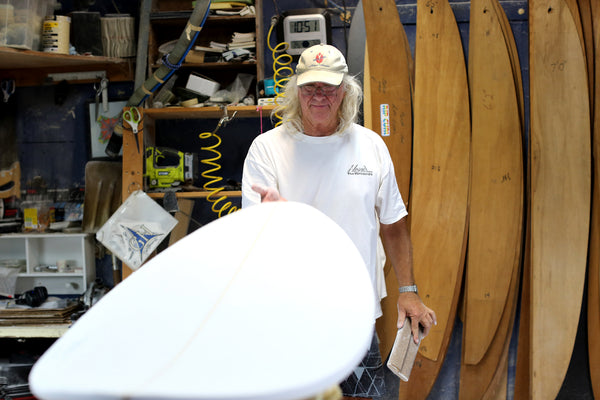 Gary Hanel working in his surfboard shaping room making surfboards