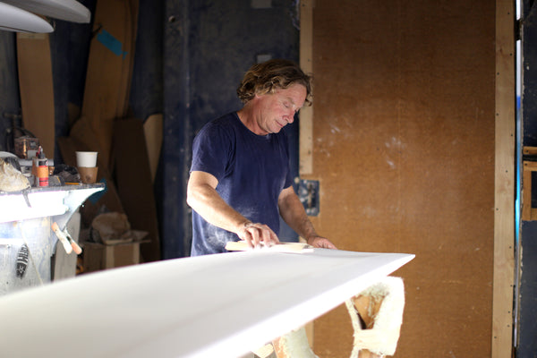 Jon Wegener shaping a surfboard in his shaping room