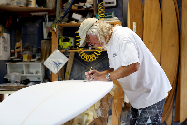 Gary Hanel working in his surfboard shaping room making surfboards